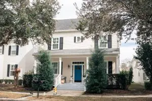 freshly painted white home exterior with blue door by smith & co Painting orlando best painters