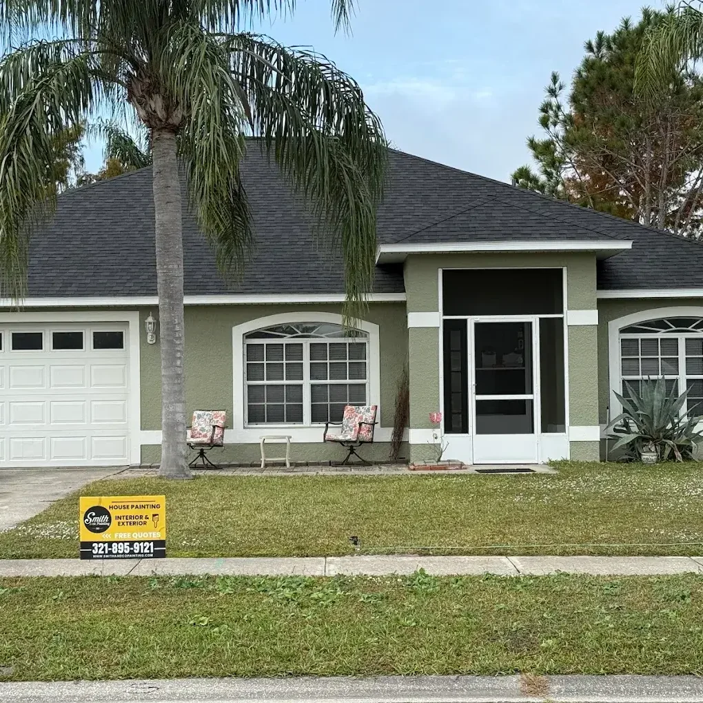 Sage green single-story home repainted with painting services in St. Cloud, FL