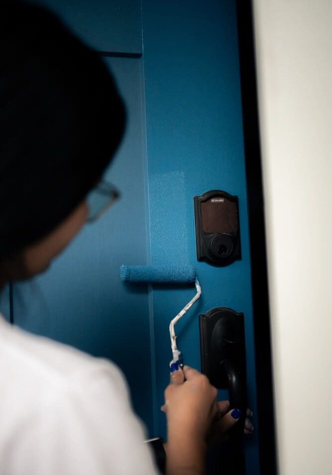 about-smith-co-painting-team smith & co painting team member painting a teal door on a home in orlando fl
