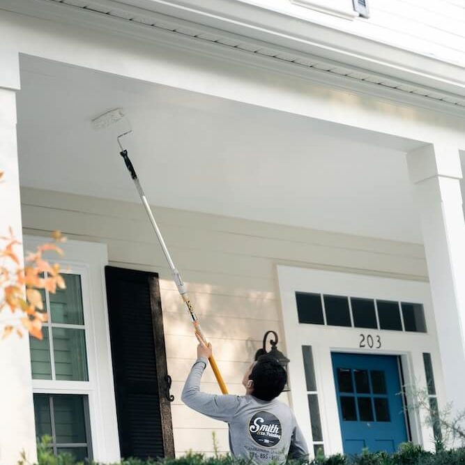 smith-and-company-painting-orlando-fl-best-painters-near-me smith & co painting painter painting the exterior of a white home in orlando fl